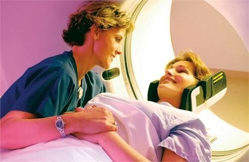 nurse helping woman in a ct scan